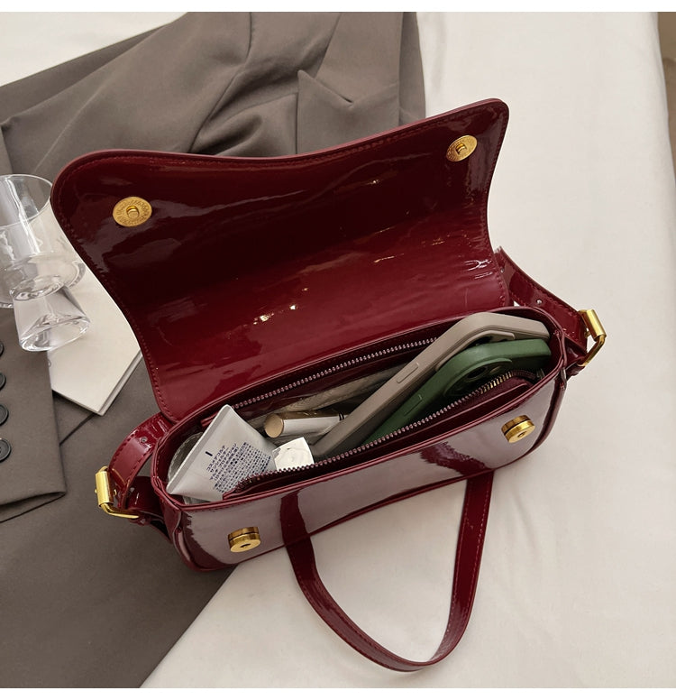 Tira | Sac bandoulière brillant au design ondulé