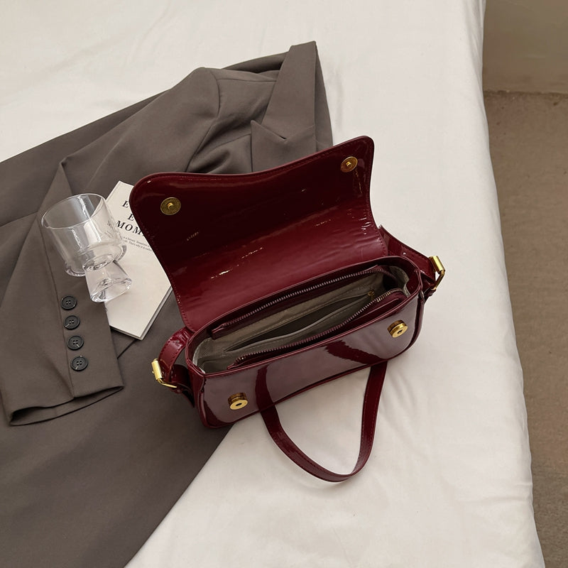 Tira | Sac bandoulière brillant au design ondulé